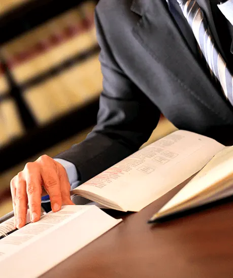 a man in a suit reading a book