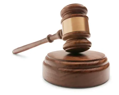 a wooden gavel on a round block