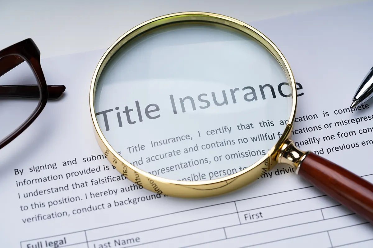 title a magnifying glass on a document of Insurance
